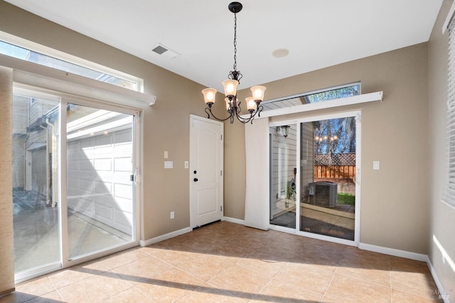 doorway to outside featuring a chandelier and light tile patterned floors