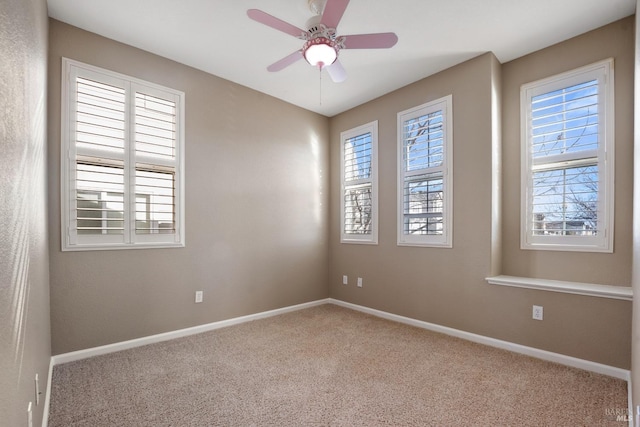 carpeted empty room featuring ceiling fan