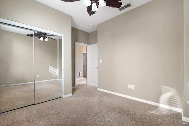 unfurnished bedroom with a closet, carpet flooring, and ceiling fan
