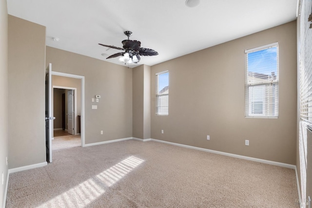 carpeted empty room featuring ceiling fan