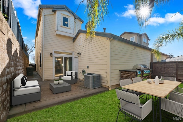 back of house featuring a yard, a patio area, cooling unit, and an outdoor living space