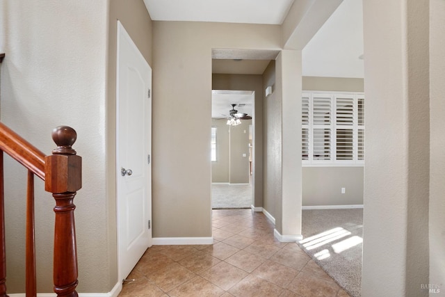 hallway featuring light tile patterned floors