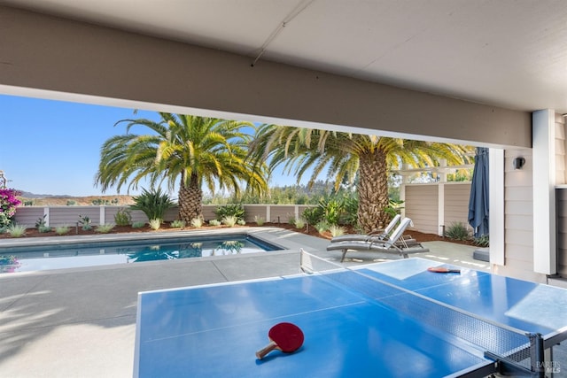 view of swimming pool with a fenced backyard, a fenced in pool, and a patio
