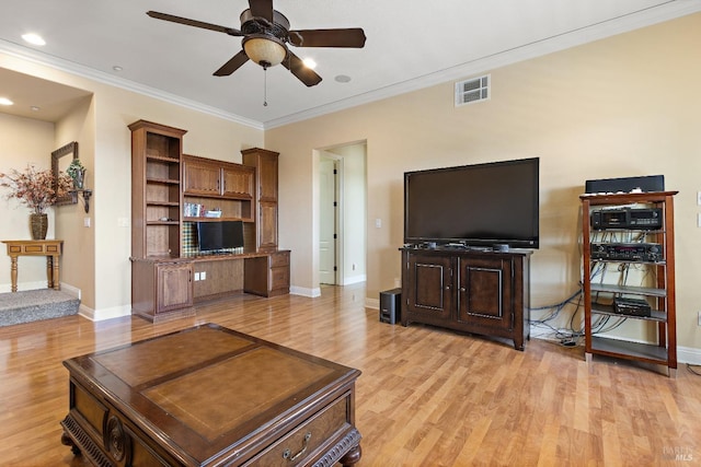 living room featuring ornamental molding, ceiling fan, and light wood-type flooring