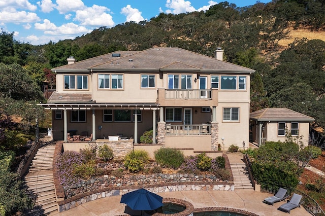 back of house featuring a patio and a balcony