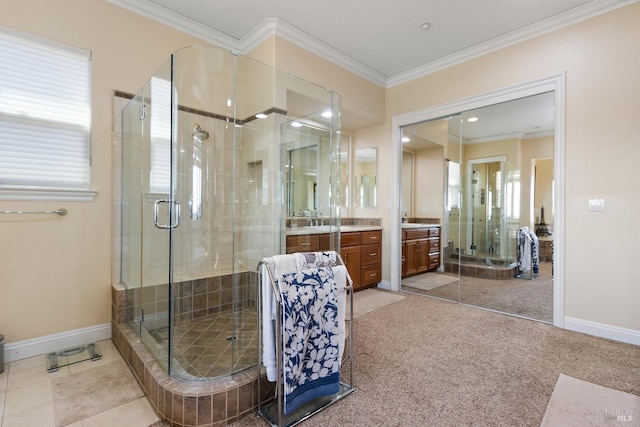 bathroom featuring ornamental molding, vanity, a shower with shower door, and a wealth of natural light