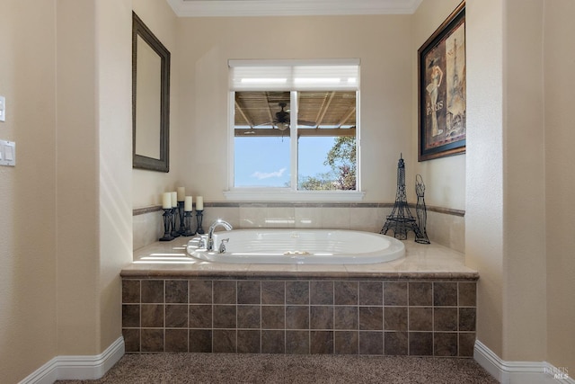 bathroom with tiled tub, crown molding, and ceiling fan