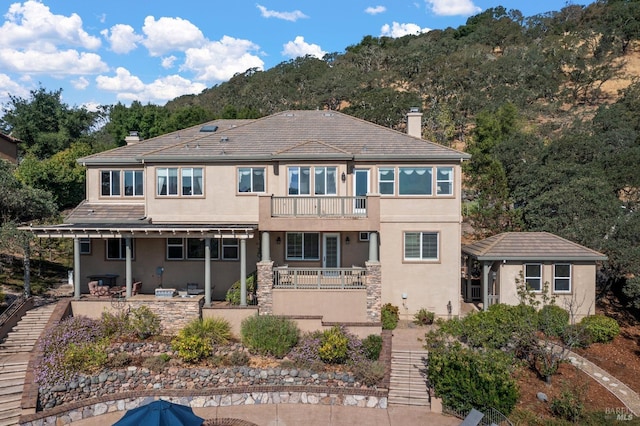 back of house with a patio and a balcony