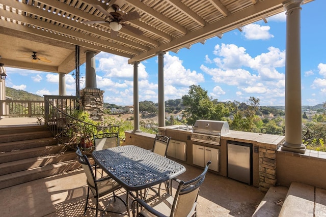 view of patio with area for grilling, a grill, and ceiling fan