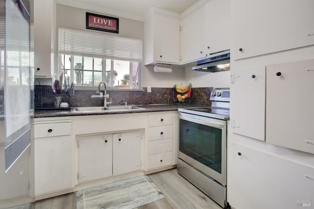 kitchen featuring crown molding, electric stove, a sink, white cabinetry, and under cabinet range hood