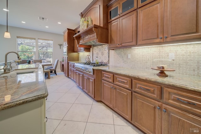 5319 Bayridge Ct, Fairfield, CA 94534 - kitchen featuring stainless steel gas stovetop, a sink, light tile patterned floors, tasteful backsplash, and light stone countertops