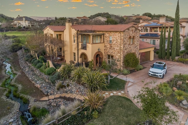 5319 Bayridge Ct, Fairfield, CA 94534 - view of front of house featuring a tiled roof, stone siding, stucco siding, concrete driveway, and a balcony