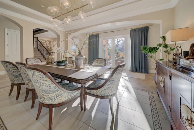 5319 Bayridge Ct, Fairfield, CA 94534 - dining area featuring arched walkways, ornamental molding, a tray ceiling, stairs, and baseboards