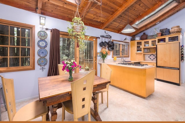 kitchen featuring stainless steel gas stovetop, vaulted ceiling with skylight, wood ceiling, and kitchen peninsula