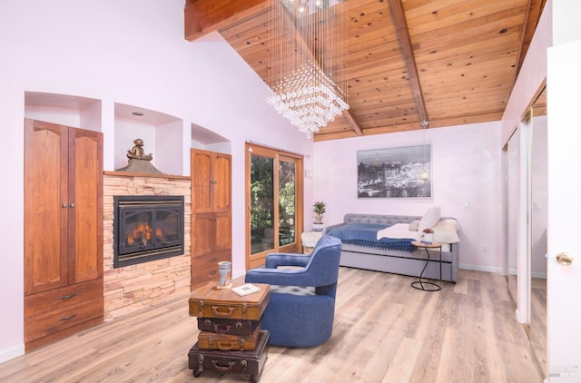 living room featuring beam ceiling, a stone fireplace, high vaulted ceiling, wood ceiling, and light wood-type flooring