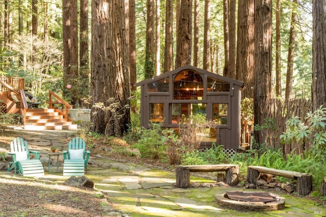 view of outbuilding featuring an outdoor fire pit