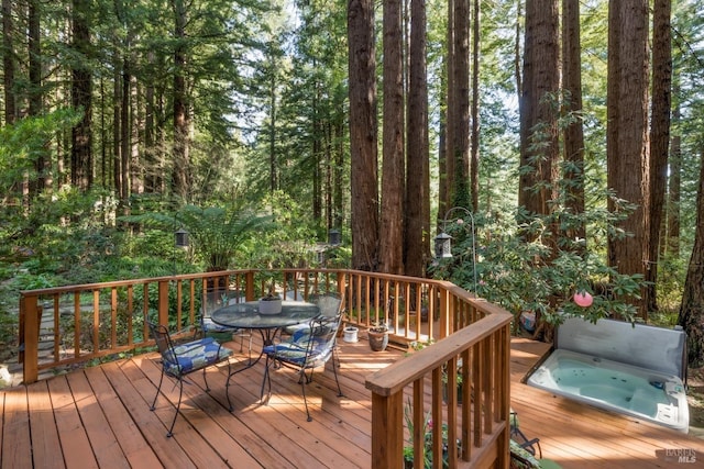 wooden terrace featuring a hot tub