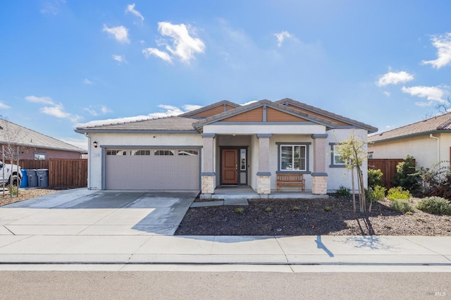 view of front of property with a garage, fence, concrete driveway, and stucco siding