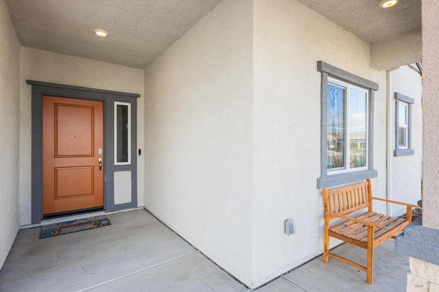 view of exterior entry featuring stucco siding