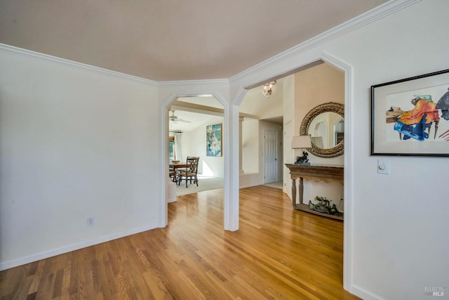 empty room featuring crown molding and wood-type flooring