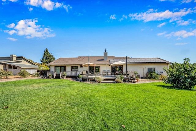 rear view of house with a lawn