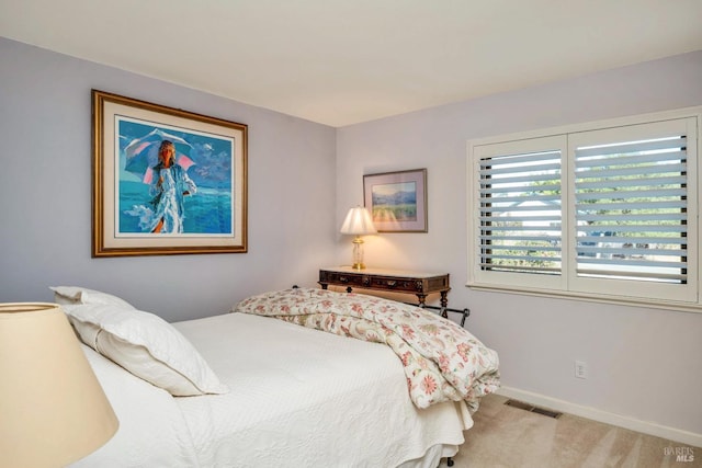 bedroom featuring light colored carpet