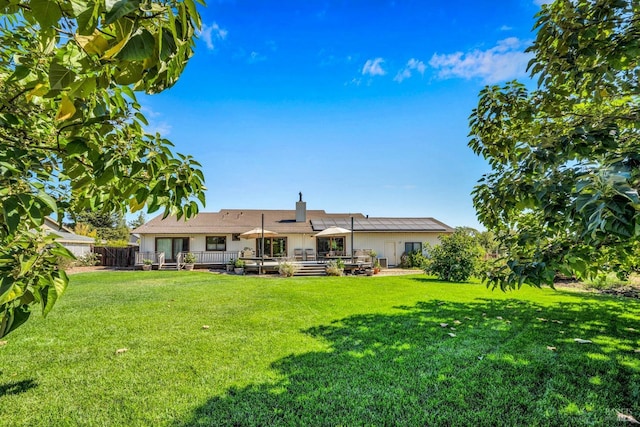 rear view of property featuring a lawn