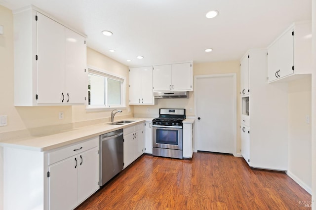 kitchen featuring stainless steel appliances, light countertops, white cabinetry, a sink, and under cabinet range hood