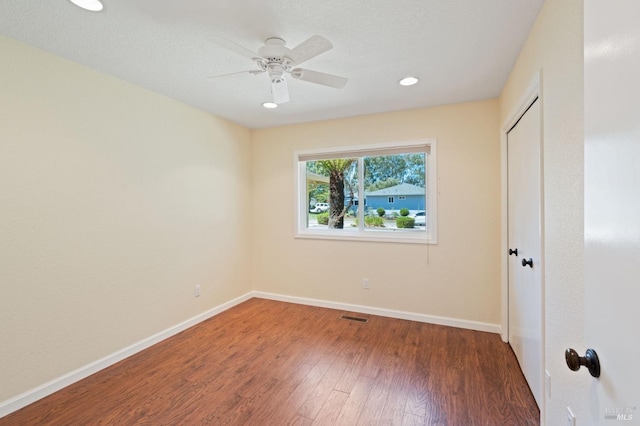 unfurnished bedroom with ceiling fan, recessed lighting, dark wood-style flooring, baseboards, and a closet