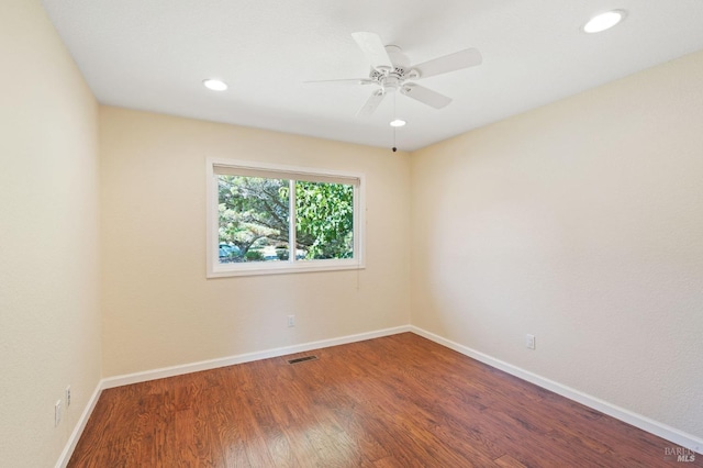 spare room featuring recessed lighting, visible vents, ceiling fan, wood finished floors, and baseboards