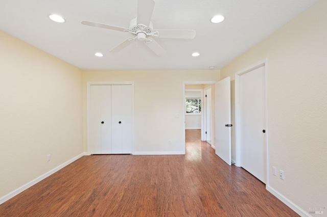 unfurnished bedroom with dark wood-style floors, recessed lighting, ceiling fan, and baseboards