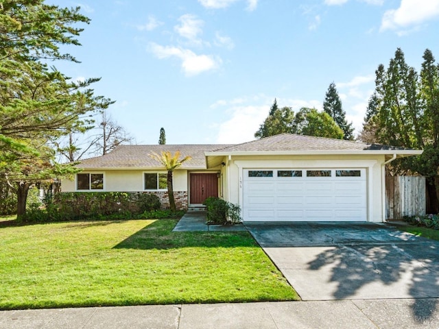 ranch-style home featuring a front yard, concrete driveway, an attached garage, and stucco siding