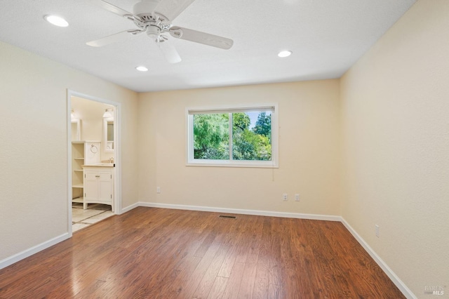 unfurnished bedroom with recessed lighting, wood finished floors, visible vents, and baseboards