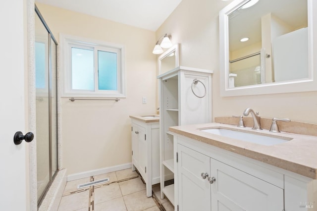 full bathroom with two vanities, visible vents, a sink, tile patterned flooring, and baseboards