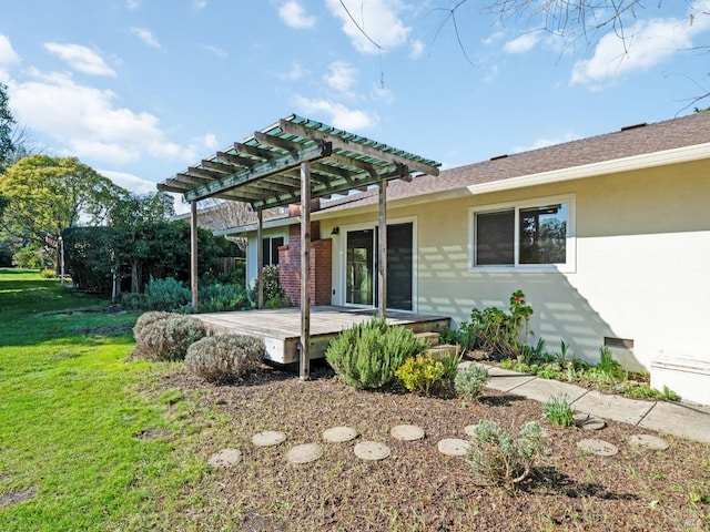 exterior space with a deck, a front lawn, a pergola, and stucco siding