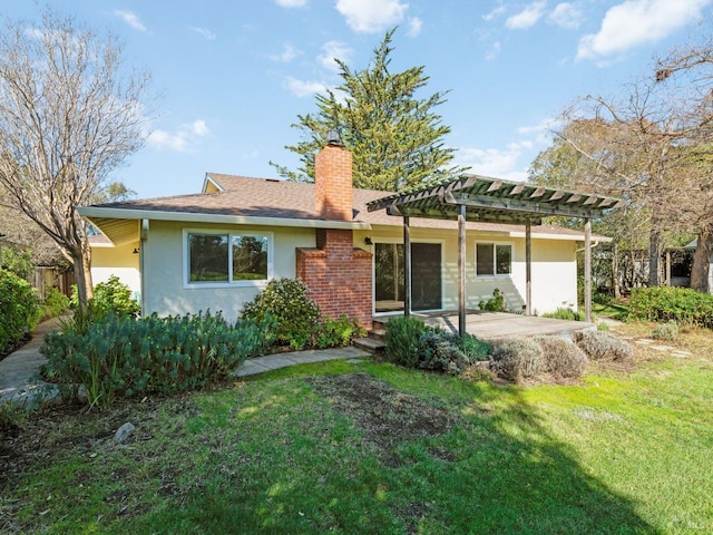 view of front of home featuring a front yard, stucco siding, a pergola, a chimney, and a patio area