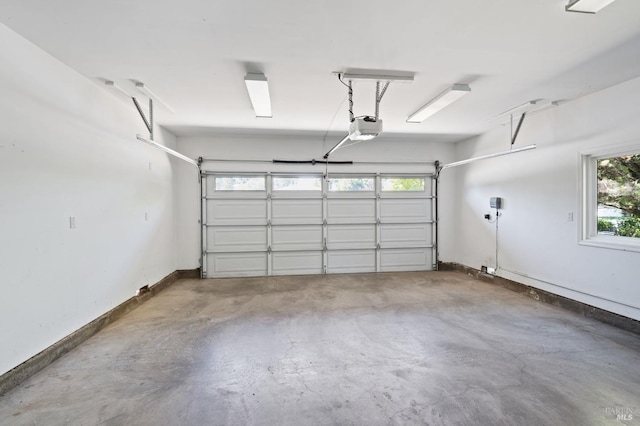 garage featuring baseboards and a garage door opener