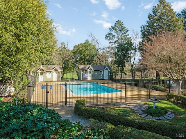 pool featuring fence, a patio, and an outdoor structure