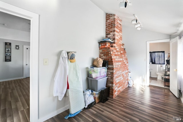 hallway featuring lofted ceiling and dark hardwood / wood-style floors