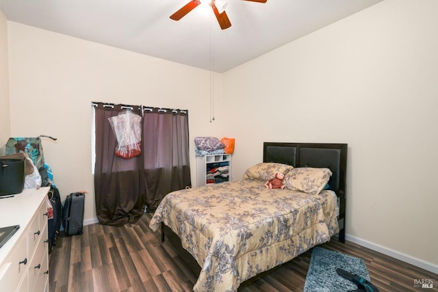 bedroom with dark hardwood / wood-style floors and ceiling fan