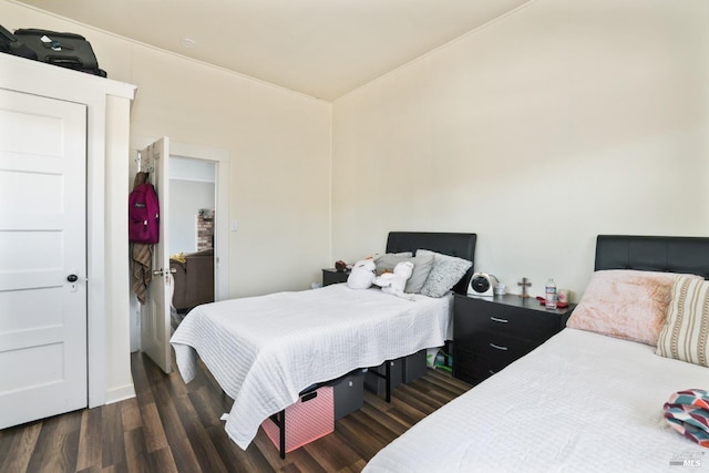 bedroom with dark hardwood / wood-style floors