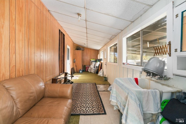 interior space with a paneled ceiling and vaulted ceiling