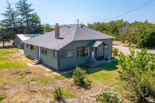 9211 Boyce Rd, Winters, CA 95694 - rear view of property featuring a chimney, roof with shingles, and a lawn