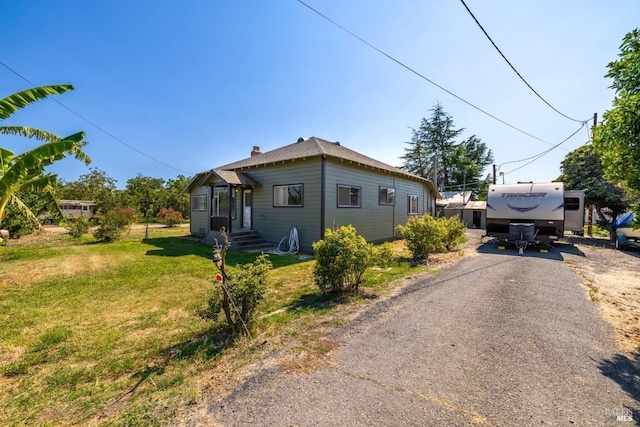 9211 Boyce Rd, Winters, CA 95694 - view of side of home featuring a yard and a chimney