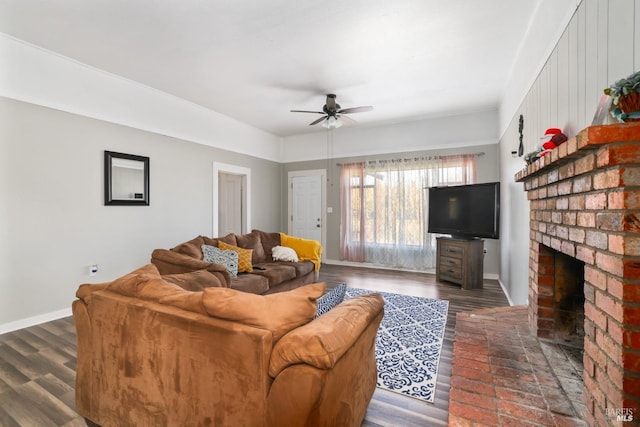 living room featuring a brick fireplace, ceiling fan, and dark wood-type flooring