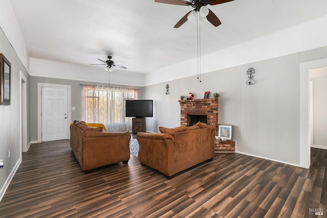 living room featuring ceiling fan, dark wood-type flooring, and a fireplace