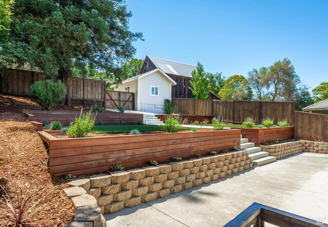 1008 Evans Ave, Napa, CA 94559 - view of patio / terrace with a fenced backyard, a wooden deck, and a vegetable garden