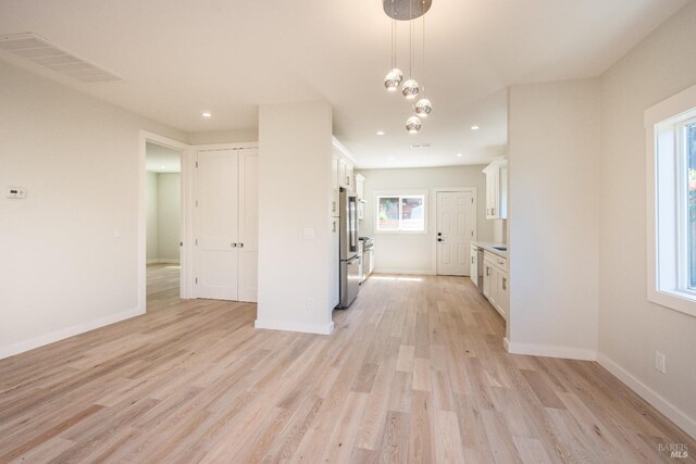 1008 Evans Ave, Napa, CA 94559 - interior space with freestanding refrigerator, light wood finished floors, white cabinetry, baseboards, and visible vents