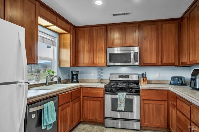 19839 Mountain Mdw S, Hidden Valley Lake, CA 95467 - kitchen with sink, tile countertops, and appliances with stainless steel finishes