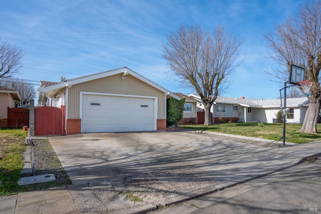 ranch-style home featuring brick siding, a front lawn, fence, concrete driveway, and a garage